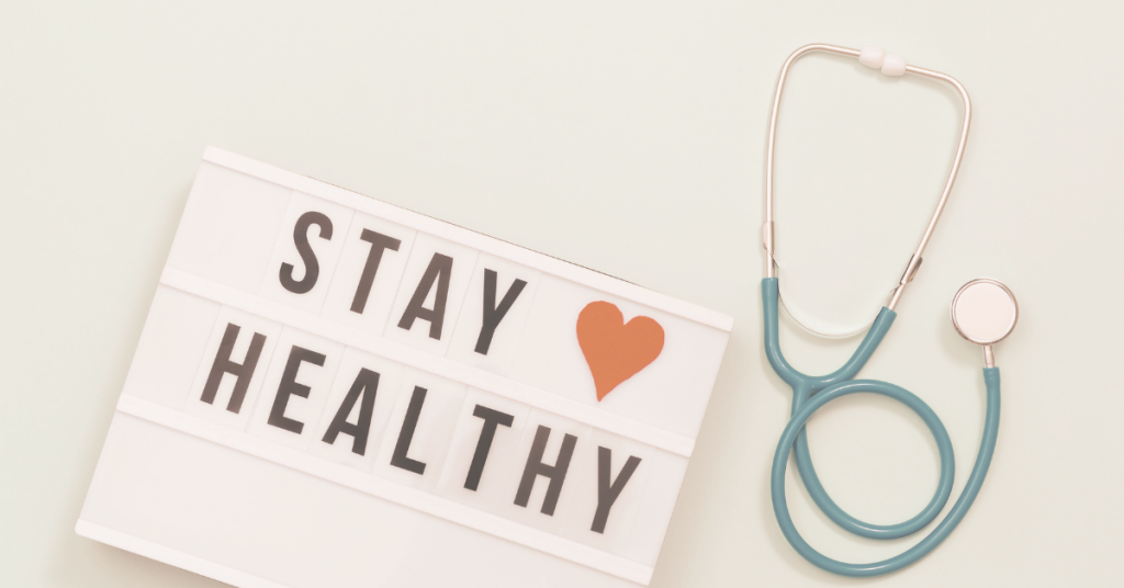 Image of a sign that says Stay Healthy with a red love heart and a stethoscope